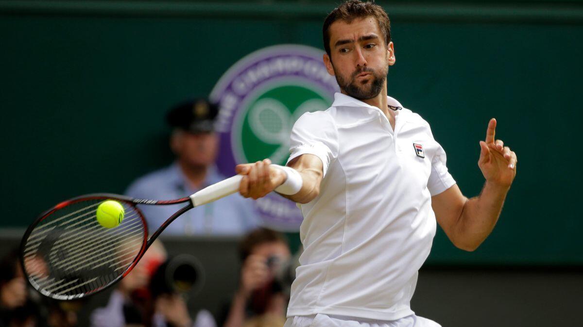 Marin Cilic returns to Sam Querrey during their men's singles semifinal match on Day 11 at the Wimbledon on Friday.