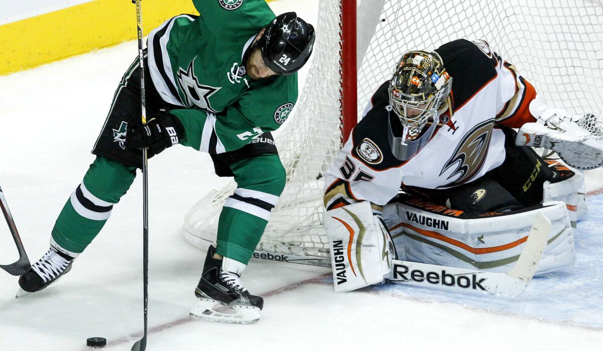 Ducks goaltender John Gibson watches Stars defenseman Jordie Benn try to gain control of the puck as the two teams play in Dallas on March 1.