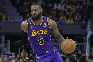 Lakers forward LeBron James dribbles during a playoff game against the Golden State Warriors in San Francisco Thursday.