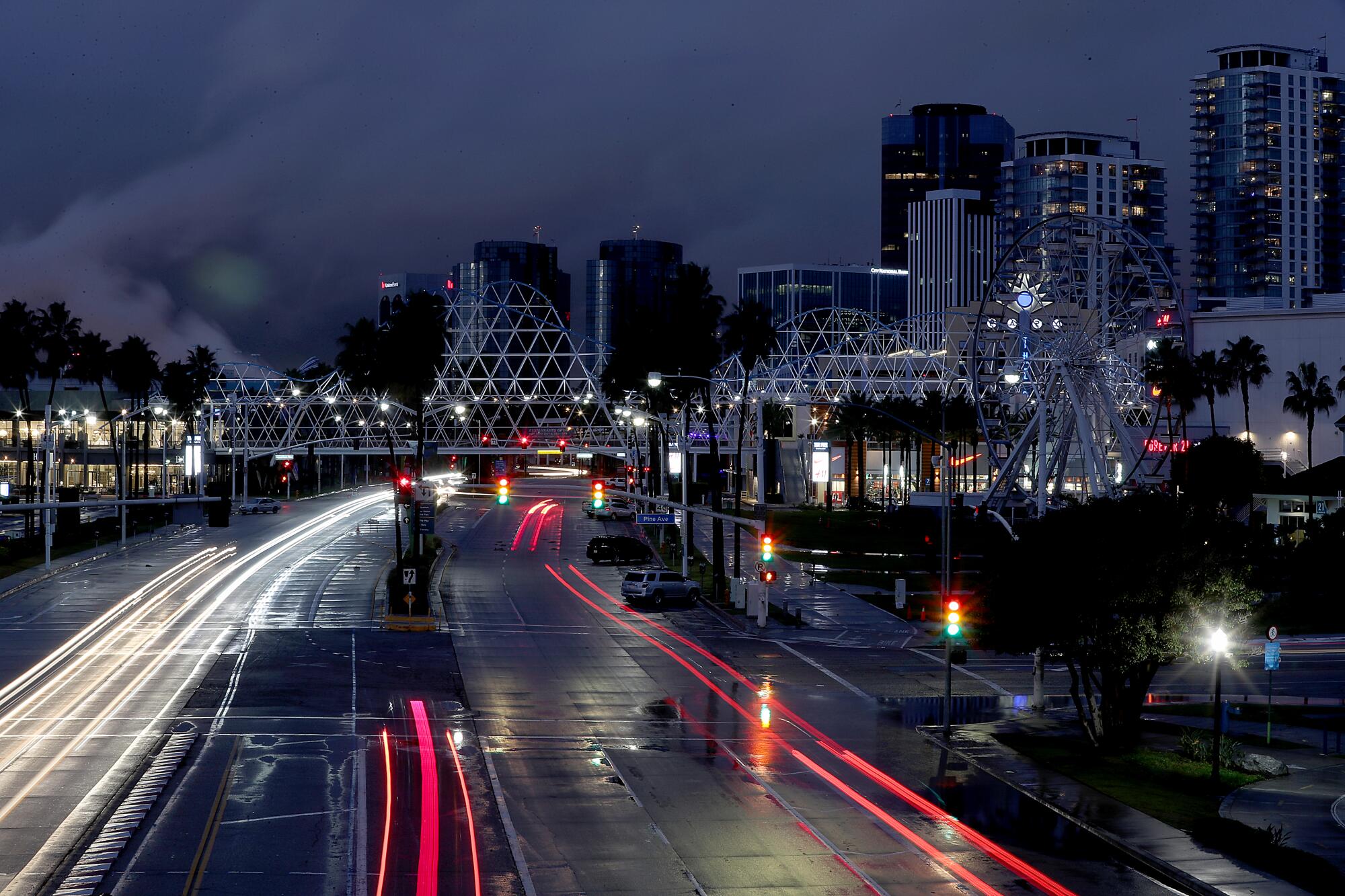 A wet and nearly empty road in downtown Long Beach.