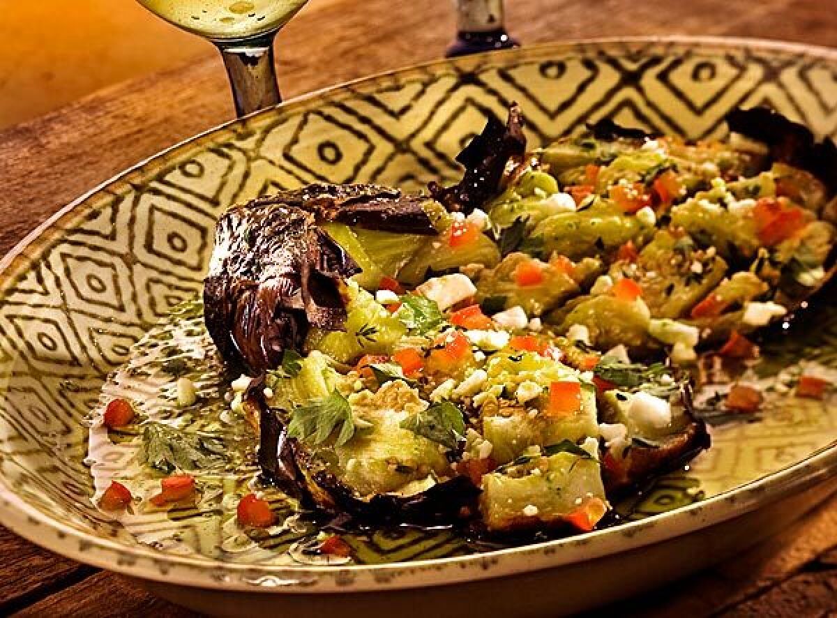 The taverna Kuzina reinvents a traditional salad, butterflied roasted eggplant.
