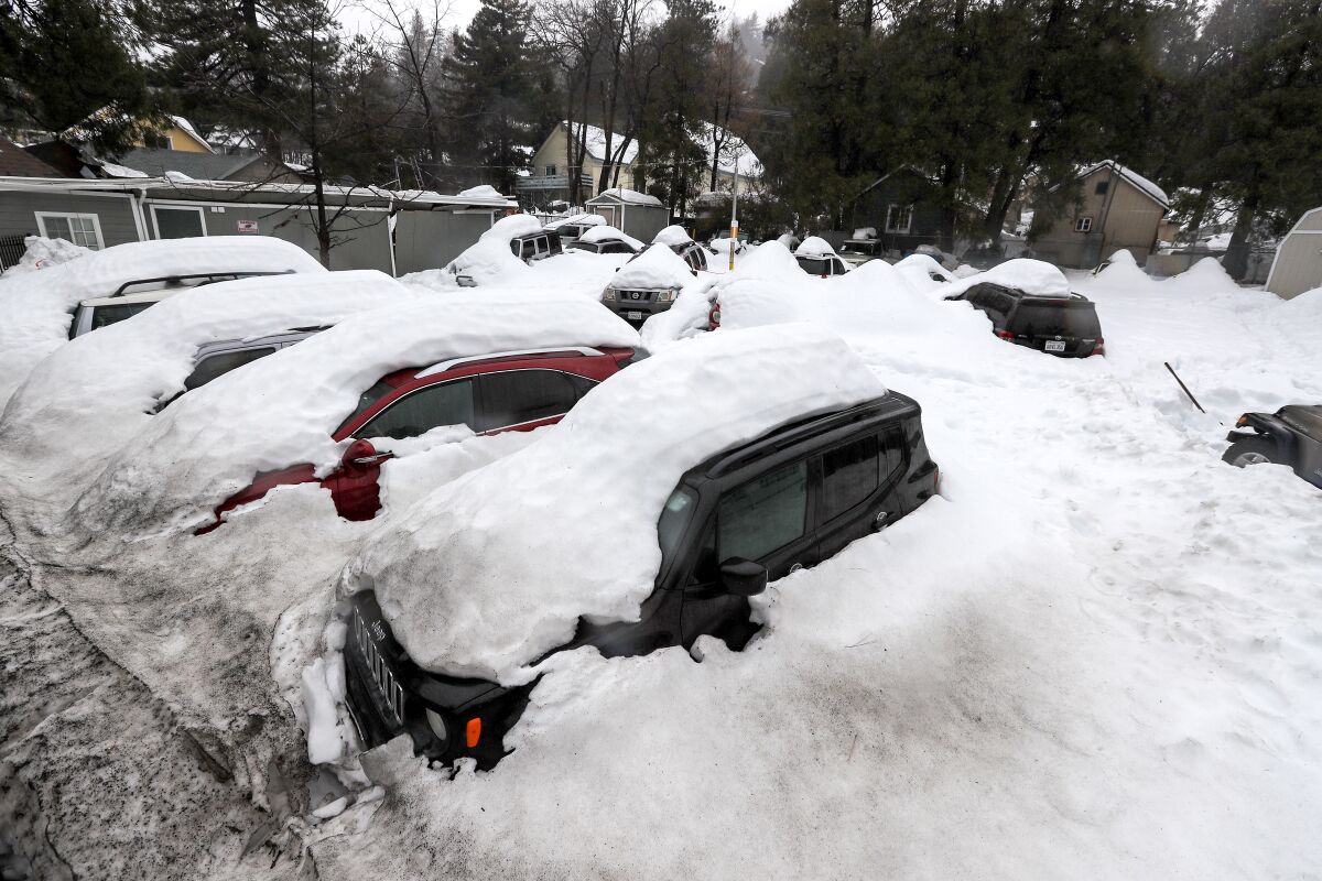 Cars buried in snow at a used-car lot in the San Bernardino mountains