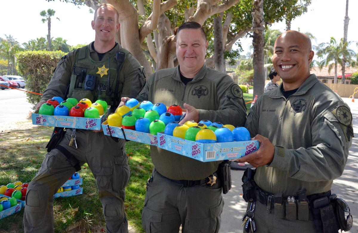 O.C. Sheriff's Department Deputy Daniel Smith, Sgt. Timm Pusztai and Investigator Ernie Ragadio prepare to place rigged eggs.