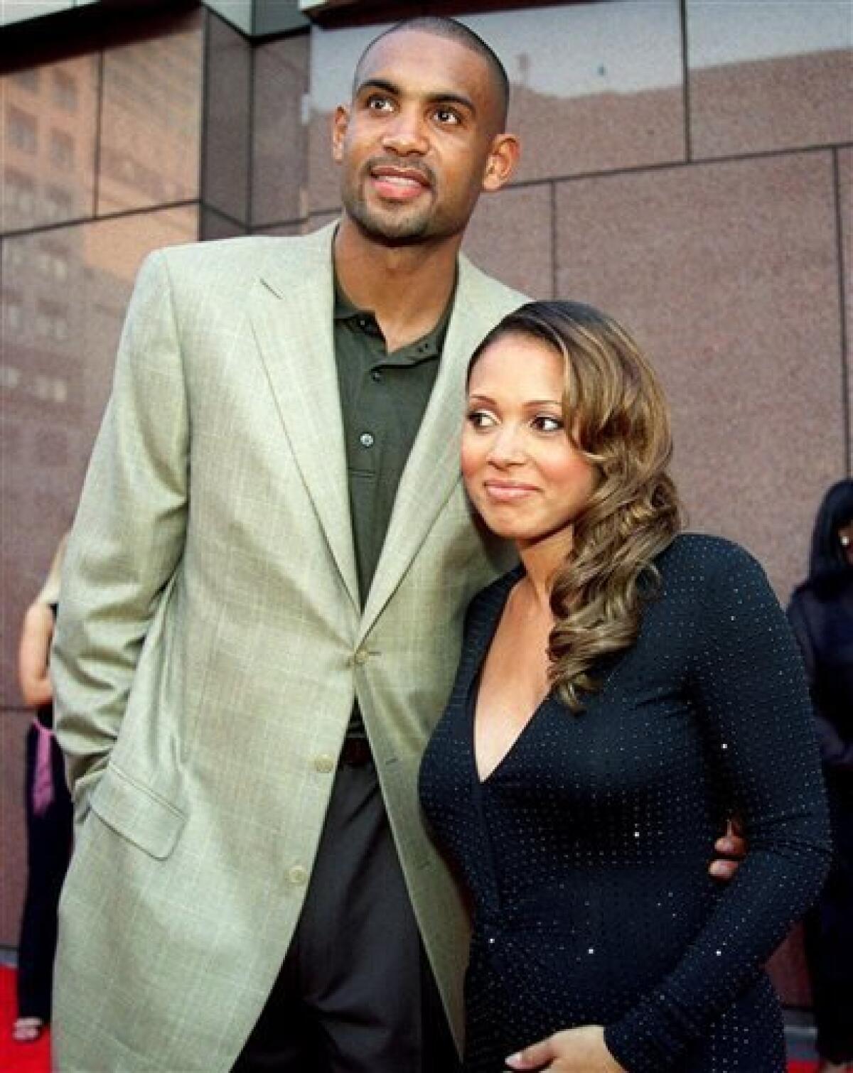 FILE - In a Sept. 7, 2001 file photo singer Tamia, right, and her husband, Grant Hill, then of the Orlando Magic, arrive fat a concert at New York's Madison Square Garden, Friday, Sept. 7, 2001. A week after he retired from the NBA, Grant Hill celebrated with his wife as she performed for a feverish crowd in New York City on Saturday night June 8, 2013. (AP Photo/Tina Fineberg)