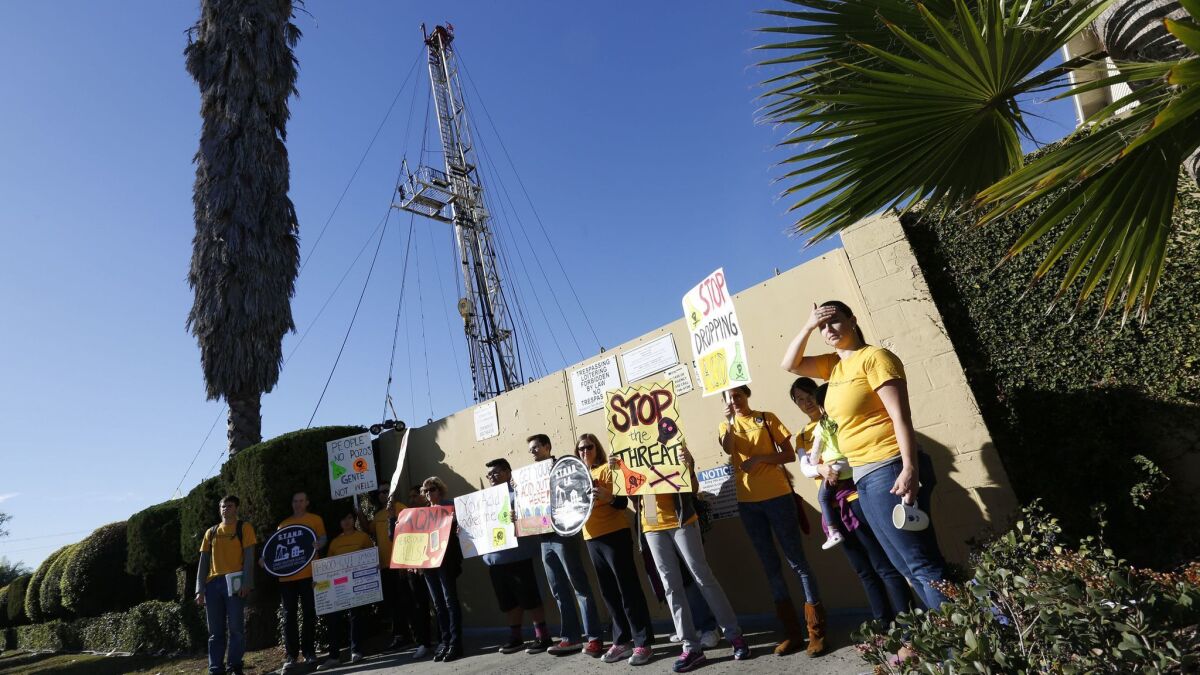 Community activists protest outside the Jefferson Boulevard oil drilling site in 2015.