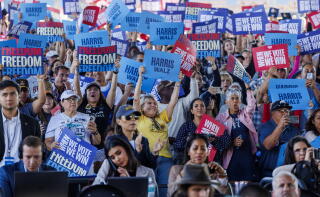 A packed crowd cheers during a campaign rally for Kamala Harris.