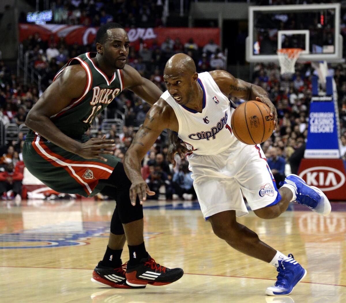 Former Clippers guard Chauncey Billups tries to get around Luc Mbah a Moute of the Milwaukee Bucks in 2013.