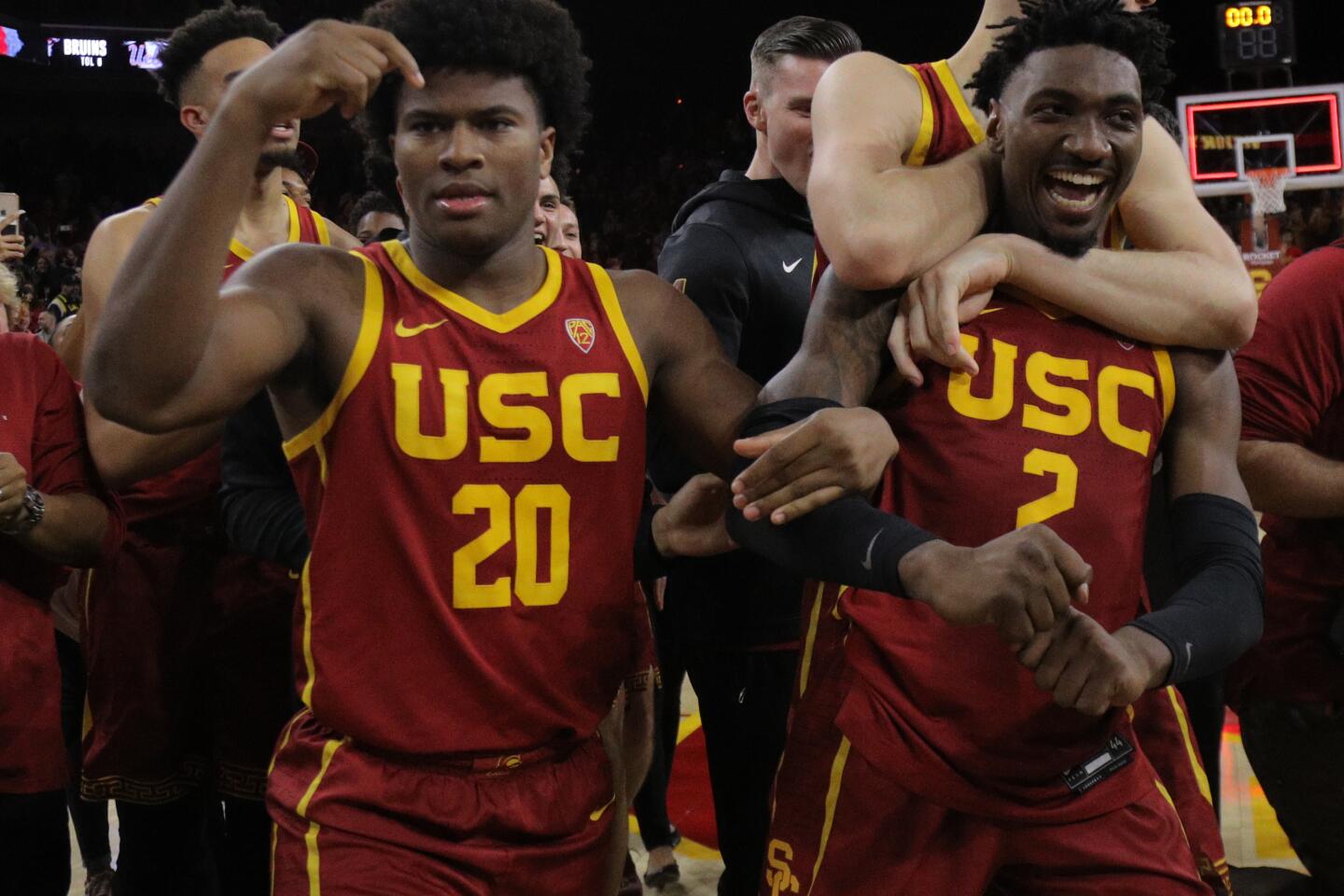 USC guard Jonah Mathews (2) celebrates with teammates Ethan Anderson (20) and Nick Rakocevic after hitting a game-winning three-pointer with less than a second remaining in a 54-52 win at Galen Center on March 7, 2020.
