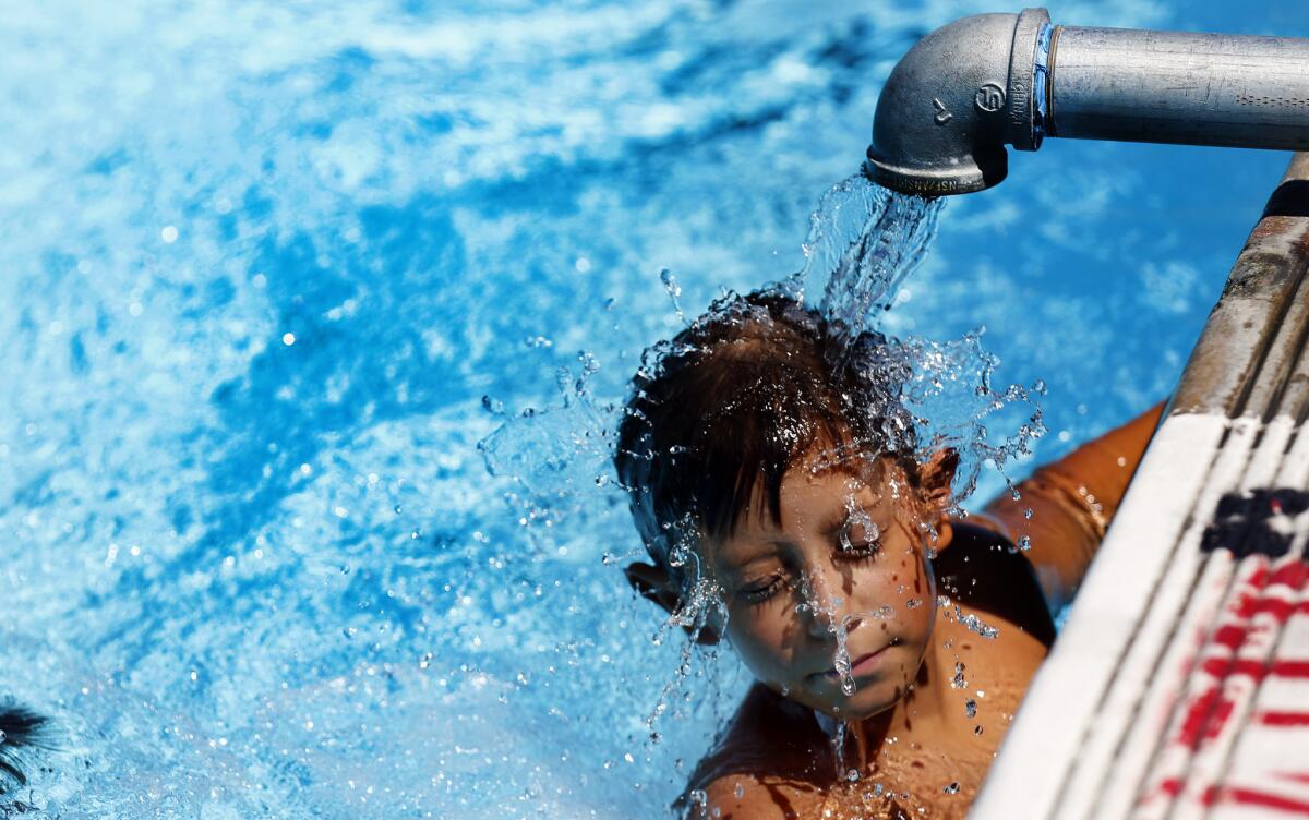 Isaiah Contreras, 11, cools off at the Highland Park swimming pool on Aug. 14.