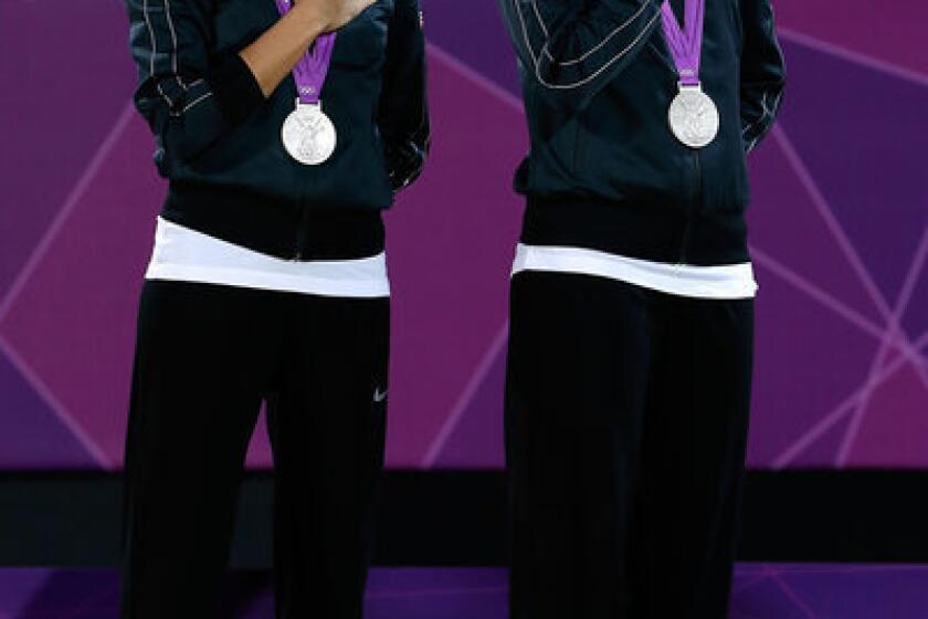 Silver medalists Jennifer Kessy and April Ross of the U.S. on the medal podium in London.