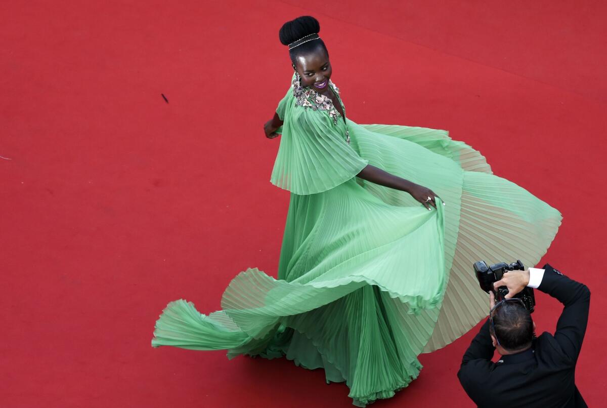 Lupita Nyong'o twirls on the red carpet as she arrives for the opening ceremony of the Cannes Film Festival on May 13.