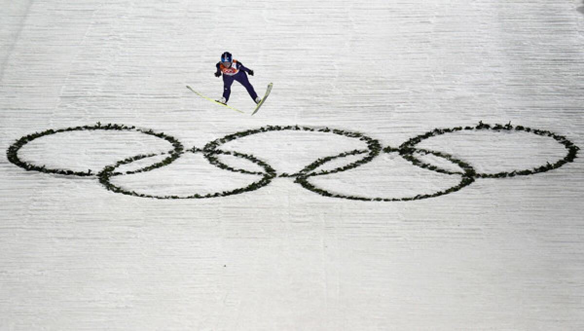 Germany's Corina Vogt jumps soars over the Olympics logo on her way to winning the first women's Olympic ski-jumping gold medal on Tuesday.