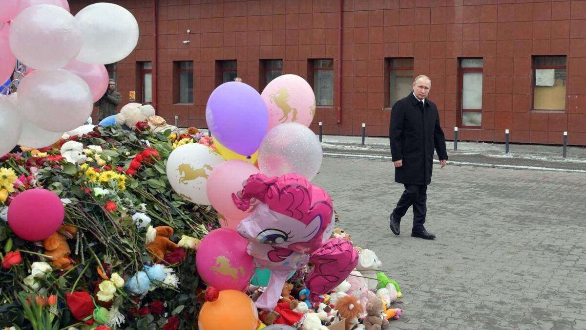 Russian President Vladimir Putin laid flowers in tribute to the victims of a fire at a shopping center in Kemerovo, Russia, on March 27, 2018.