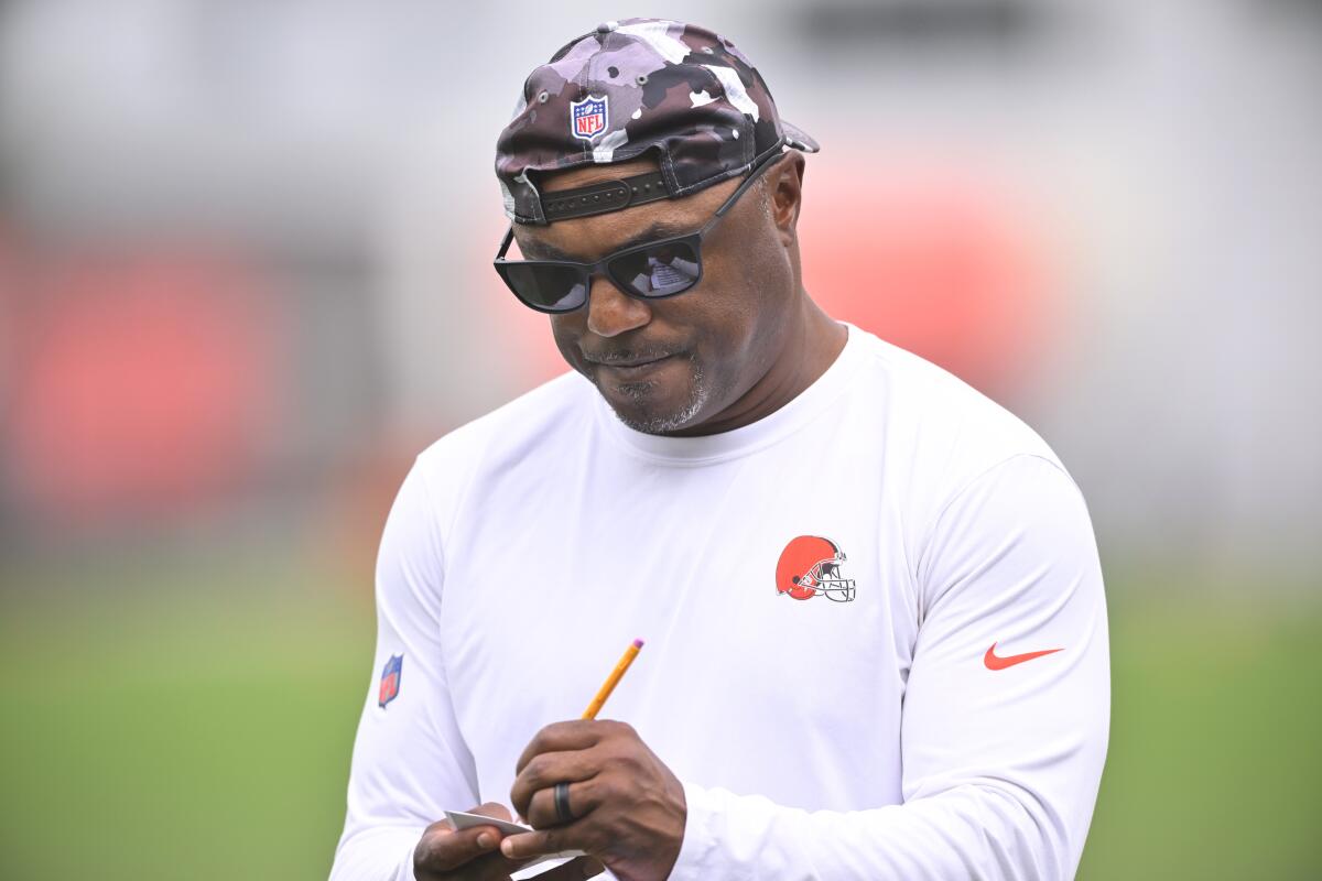 FILE - Cleveland Browns defensive coordinator Joe Woods takes notes during an NFL football practice at the team's training facility Wednesday, June 8, 2022, in Berea, Ohio. Cleveland's defense has underperformed through five games and defensive coordinator Joe Woods is feeling the heat from a fan base demanding better and seeing little improvement. (AP Photo/David Richard, File)