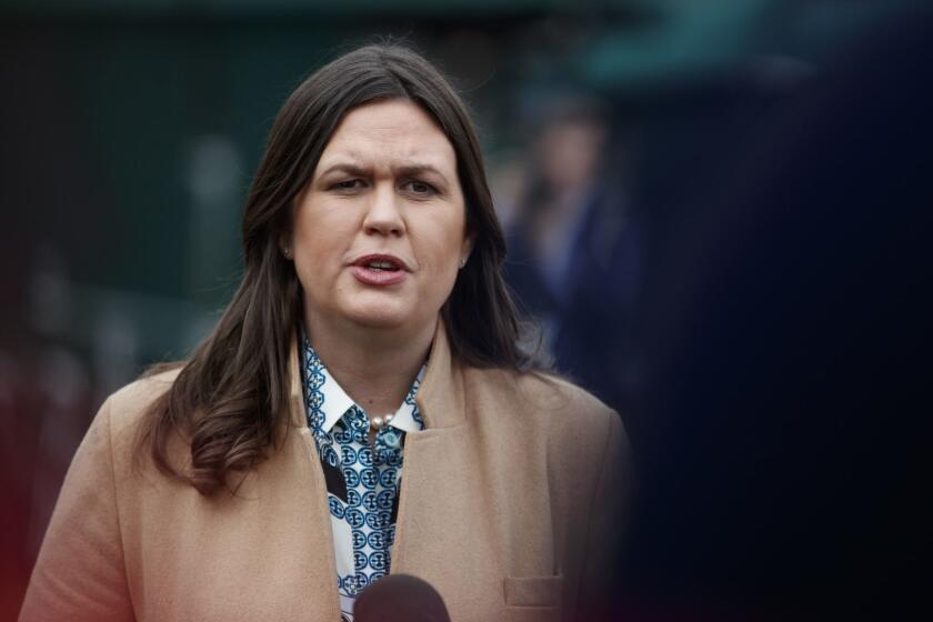 White House press secretary Sarah Sanders talks with reporters outside the White House in Washington, Friday, Feb. 15, 2019. (AP Photo/Carolyn Kaster)