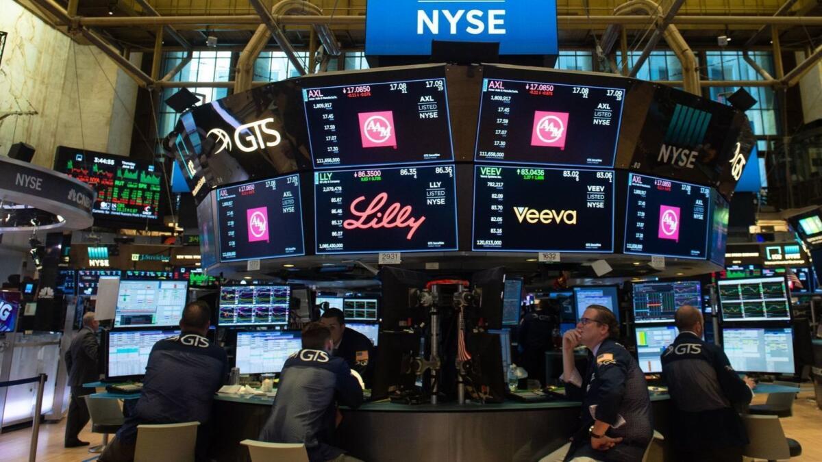 Traders work on the floor of the New York Stock Exchange.