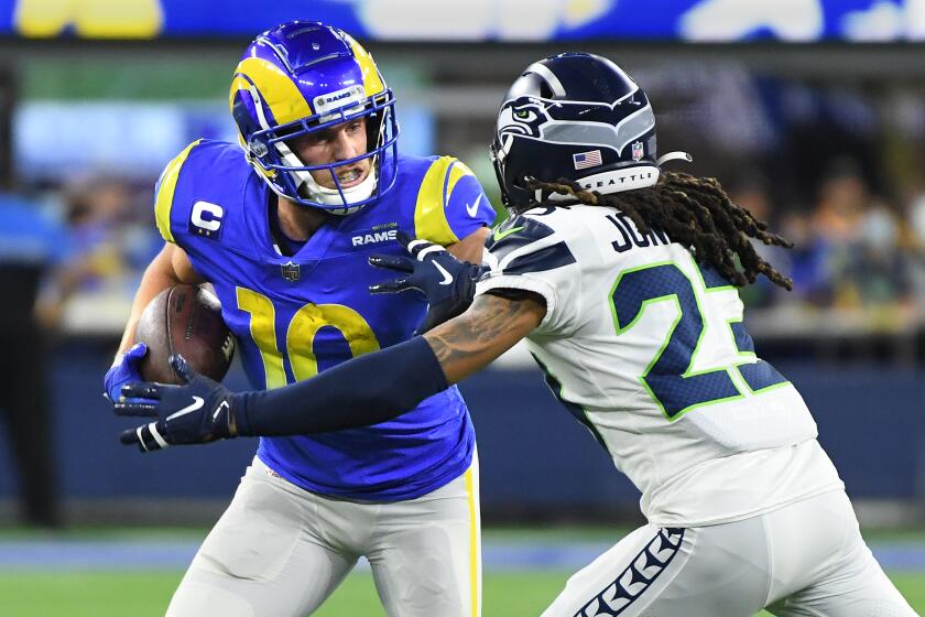Inglewood, California December 21, 2021: Rams receiver Cooper Kupp makes a reception in front of Seahawks cornerback Sidney Jones in the second quarter at SoFi Stadium Tuesday in Inglewood. (Wally Skalij/Los Angeles Times)