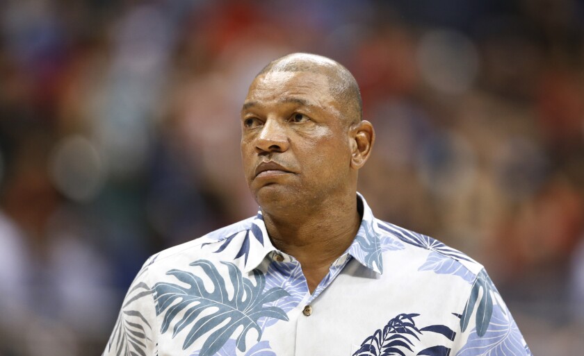 Clippers coach Doc Rivers watches his team play a preseason game against the Rockets.