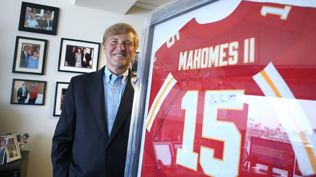 Newport Beach sports agent Leigh Steinberg will host an agent academy for prospective sports agents on Saturday. Steinberg stands with the framed jersey of client Patrick Mahomes II of the Kansas City Chiefs, a quarterback who was the No. 10 pick in the 2017 NFL Draft.