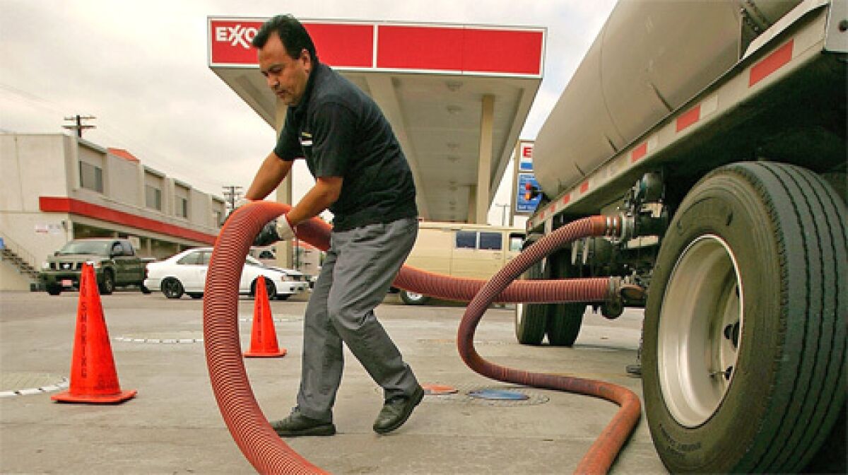 FILL ER UP: Marcos Moran delivers gas to an Exxon station in Burbank last week. U.S., British and Dutch courts have approved a request to block Petroleos de Venezuela from selling foreign assets