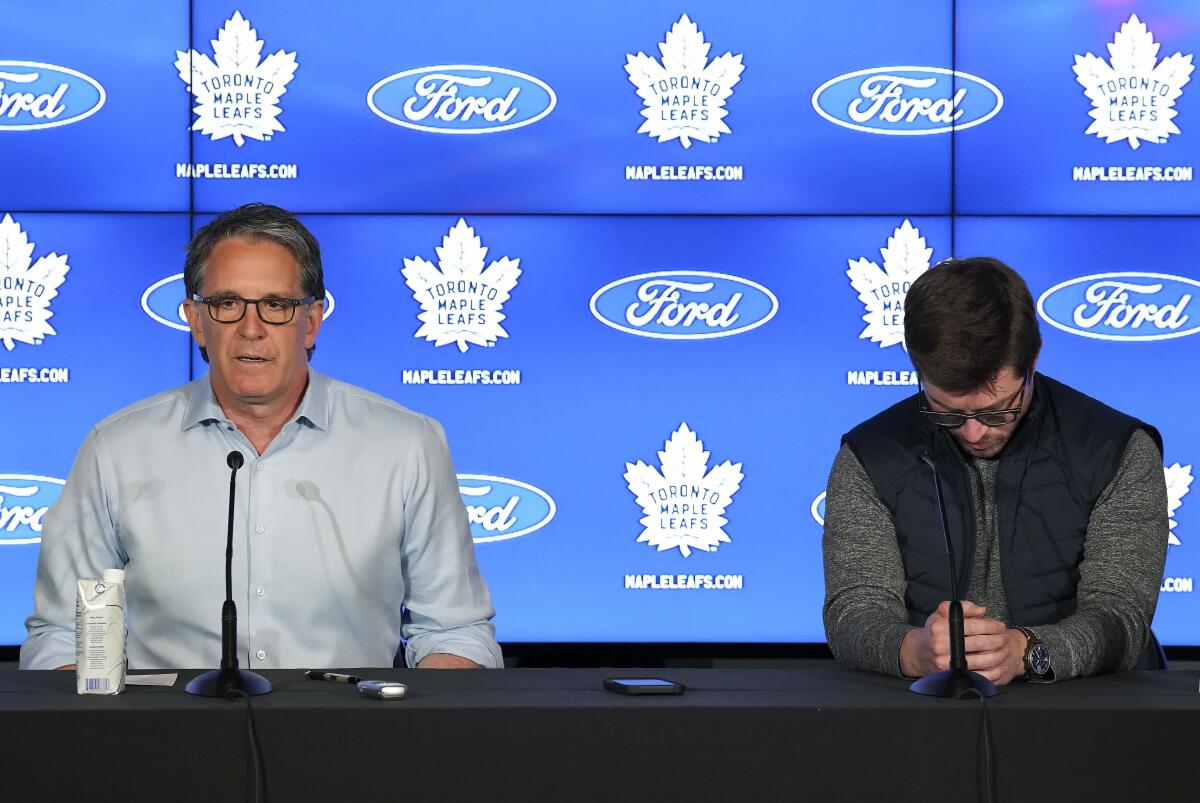 Brendan Shanahan, left, President of the Toronto Maple Leafs and Maple Leafs general manager Kyle Dubas speak to the media after being eliminated in the first round of the NHL Stanley Cup hockey playoffs, during a press conference in Toronto on Tuesday, May 17, 2022. (Nathan Denette/The Canadian Press via AP)