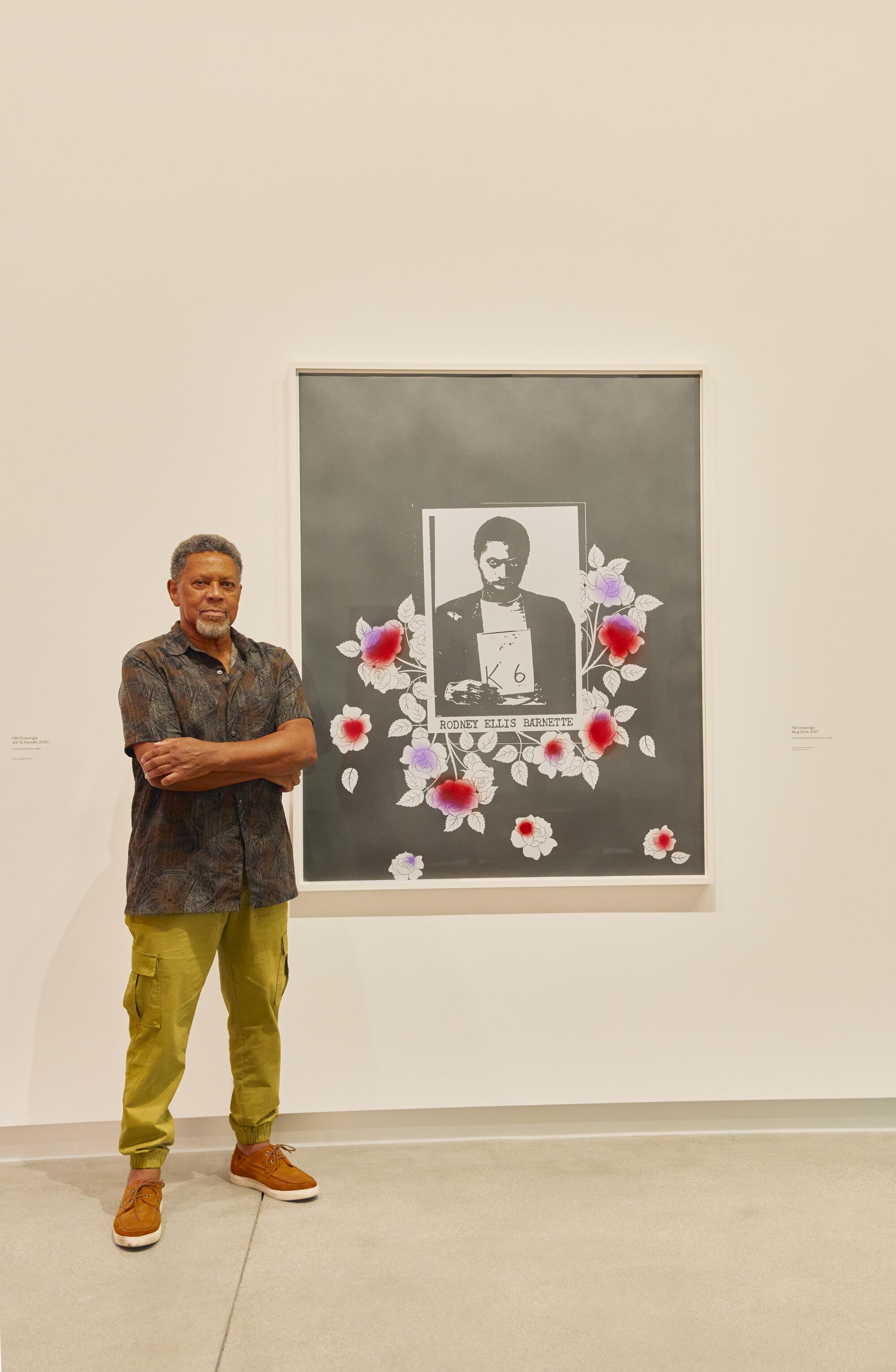Rodney Barnette stands in front of artwork by his daughter, Sadie Barnette, at her show: Legacy and Legend