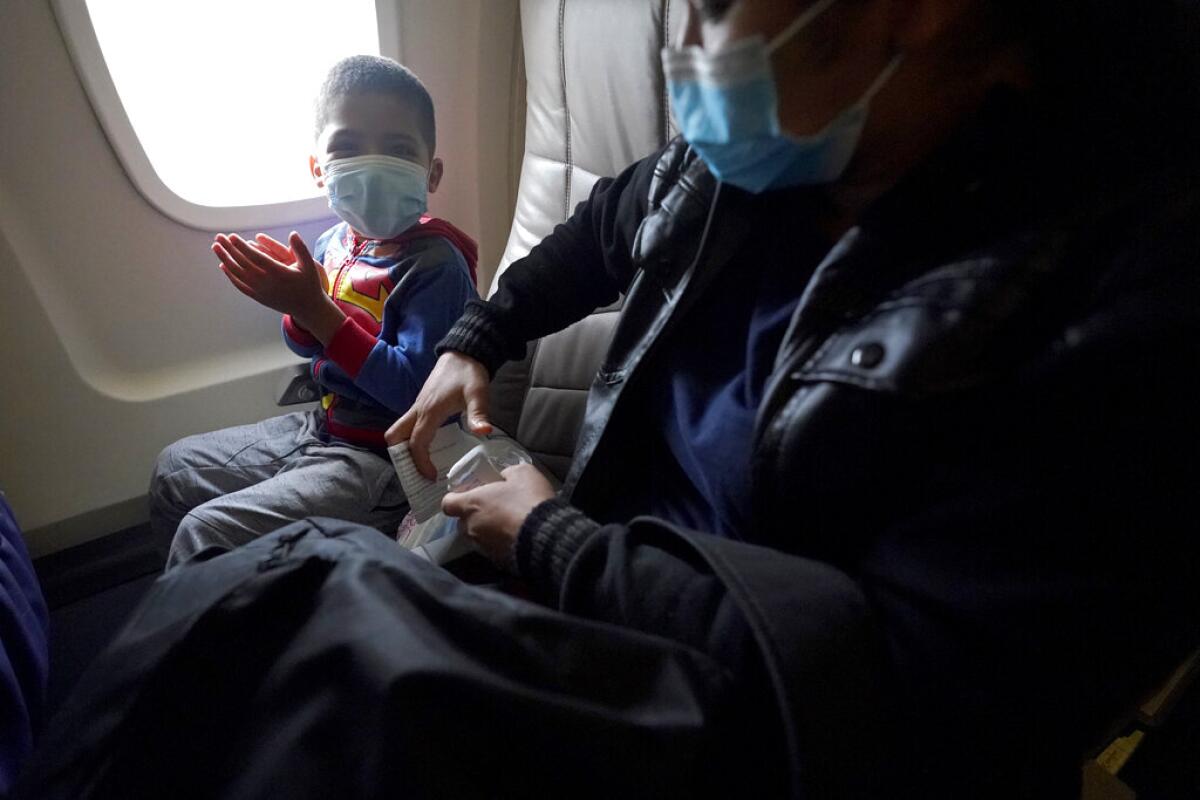 Yancarlos Amaya, de 5 años, aplaude mientras se prepara para tomar un vuelo por primera vez con su madre