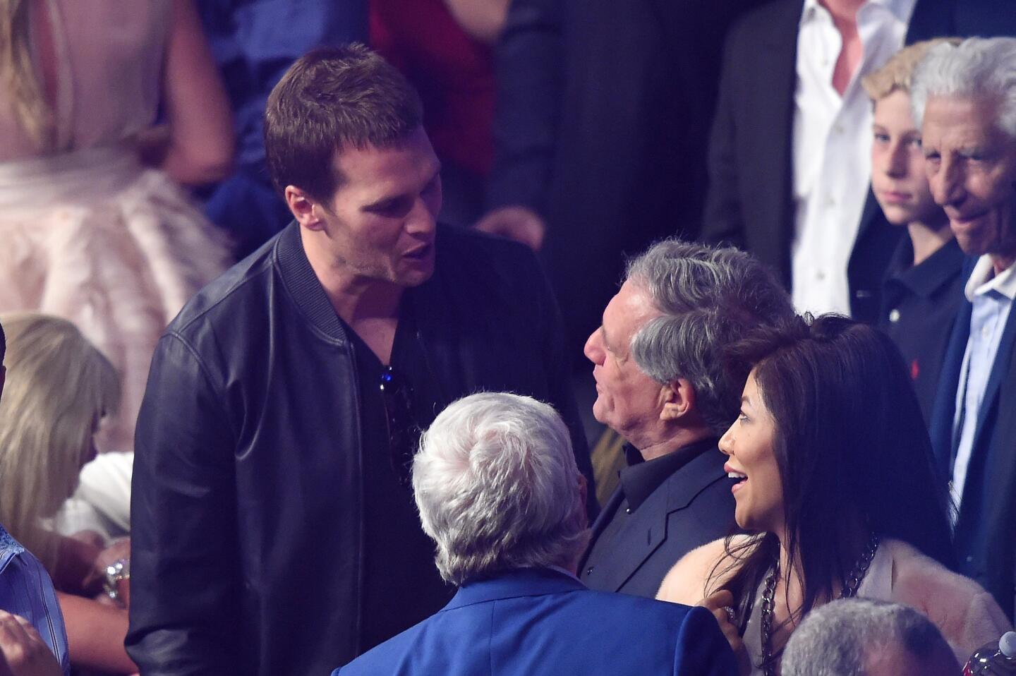 New England Patriots quarterback Tom Brady talks with Leslie Moonves and Julie Chen before the welterweight unification championship bout between Floyd Mayweather Jr. and Manny Pacquiao on Saturday night.