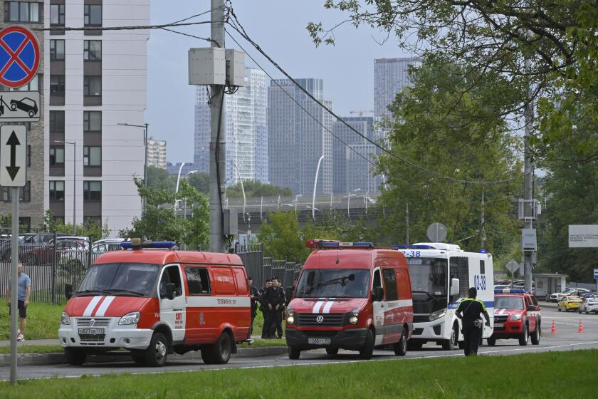 Police and emergency vehicles parked at the side of the wreckage of the drone fell near the Karamyshevskaya embankment to the after a reported drone attack in Moscow, Russia, on Friday, Aug. 11, 2023. The Mayor of Moscow, Sergei Sobyanin said a drone fell in western Moscow after it was shot down by air defense systems. Sobyanin said no-one was hurt when the drone fell near Karamyshevskaya embankment and that no serious damage was caused. Russian social media channels shared videos of what they said was a drone flying low above Moscow and of smoke rising above the Moscow river. (AP Photo)