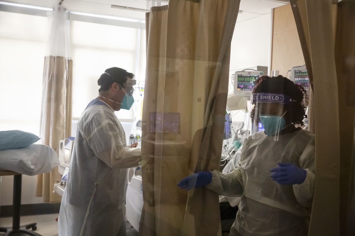 Hospital doctors and nurses treat COVID-19 patients