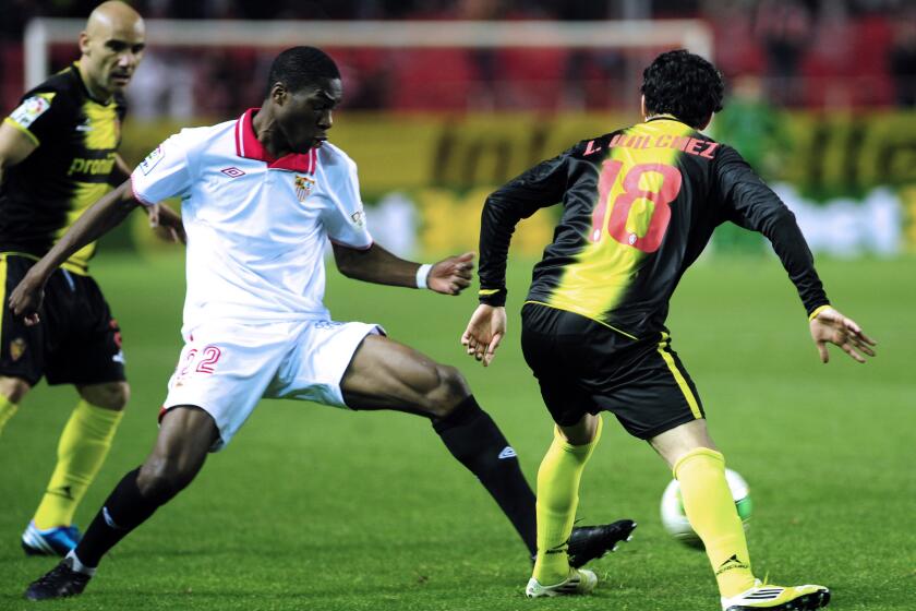 Sevilla's French midfielder Geoffrey Kondogbia (C) vies with Zaragoza's Argentinian midfielder Lucas Wilchez (R) during the Spanish Copa del Rey (King's Cup) quarter final, second leg, football match Sevilla FC vs Zaragoza at the Ramon Sanchez Pizjuan stadium in Sevilla on January 23, 2013. AFP PHOTO/ CRISTINA QUICLER (Photo credit should read CRISTINA QUICLER/AFP via Getty Images)