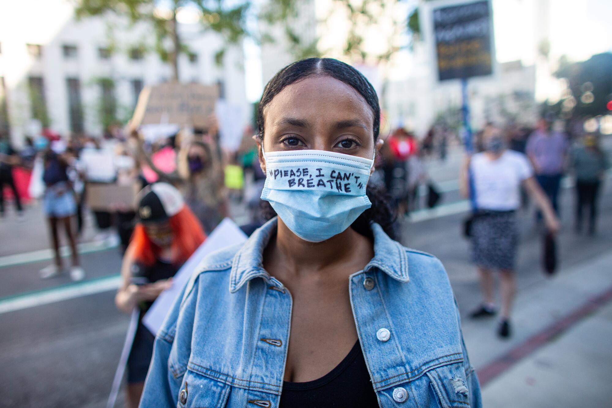 Harina Yacob, 26, of Los Angeles wears a mask reading, "Please, I can't breathe."