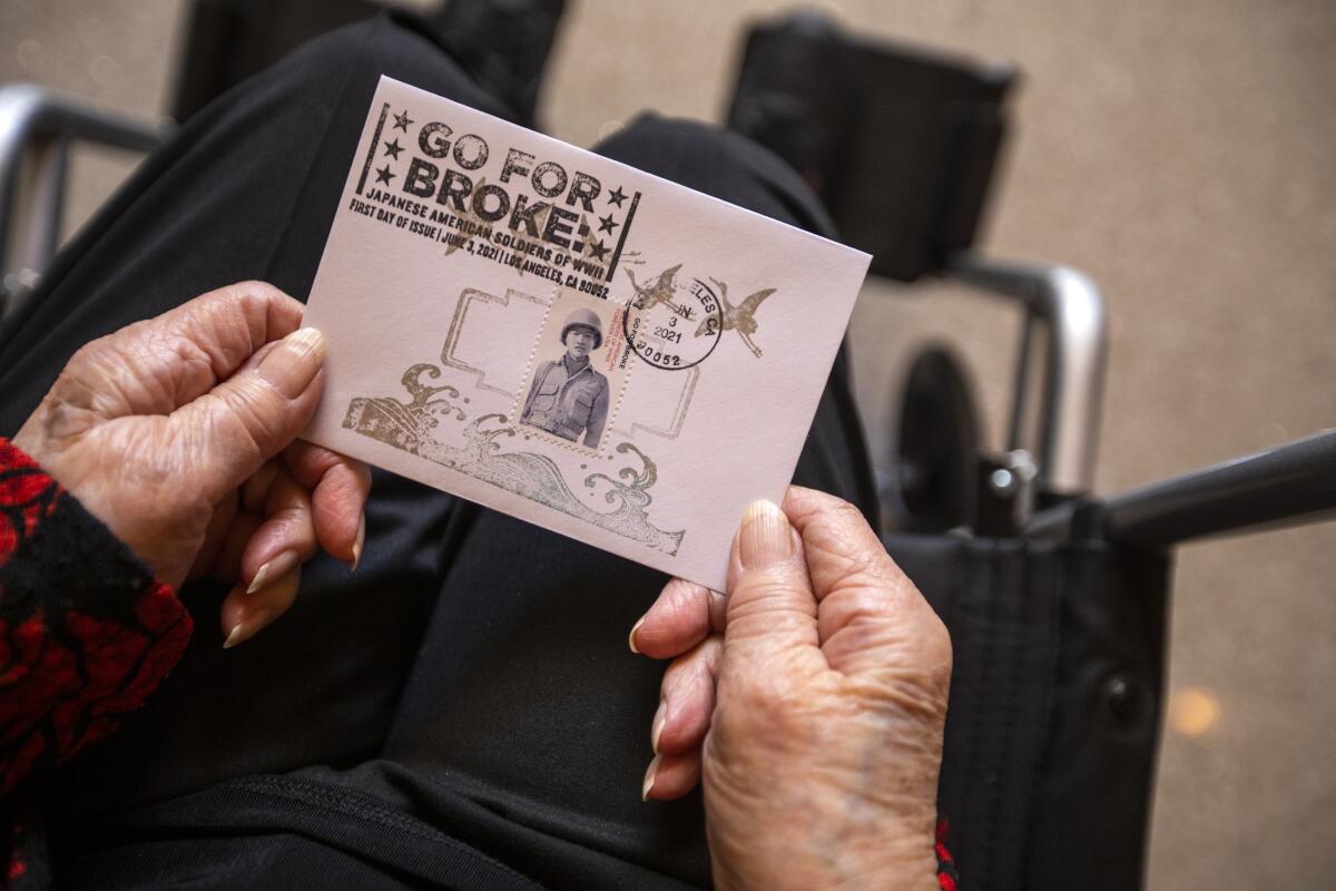 Closeup of a card being held by a person in a wheelchair. 