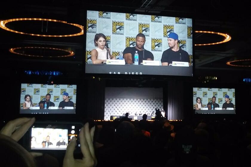 At the "Arrow" panel at Comic-Con, Willa Holland, David Ramsey and Stephen Amell talk to the crowd.