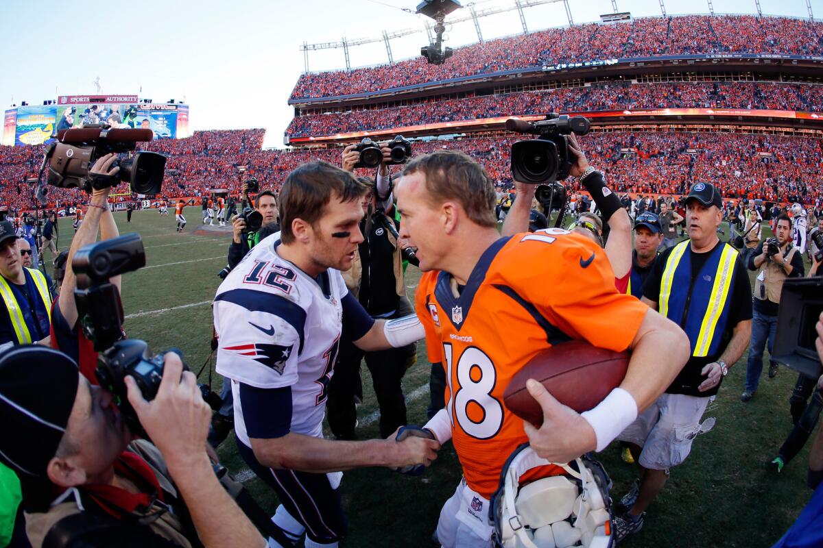 Patriots quarterback Tom Brady (12) congratulates Broncos quarterback Peyton Manning after the AFC championship game in January 2014.