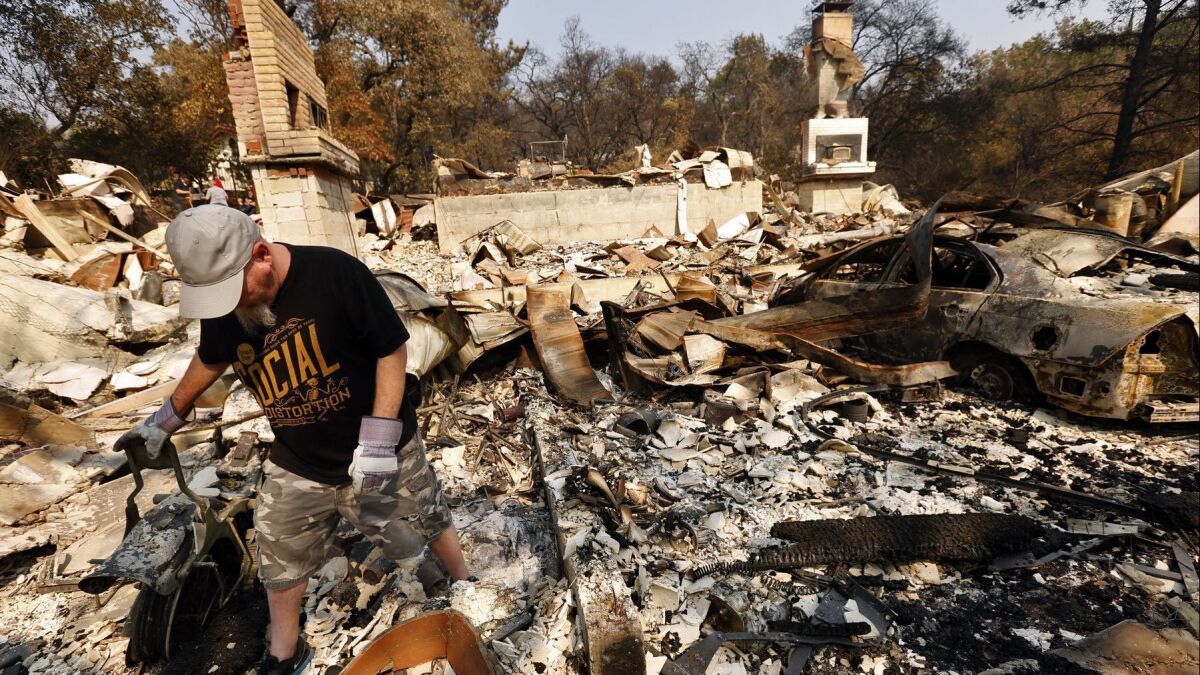 Phil Nelsen walks through the rubble of his grandfather's home that was destroyed in the Atlas fire in Napa on Oct. 13.