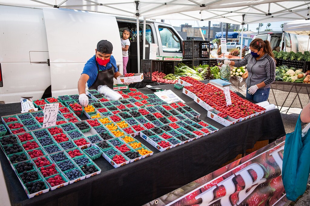 XXXX Family Farm of San Luis Obispo County sets out its collection of produce for Pacific Beach's Garnet Avenue farmers market, which returned May 19 after being closed because of coronavirus restrictions.