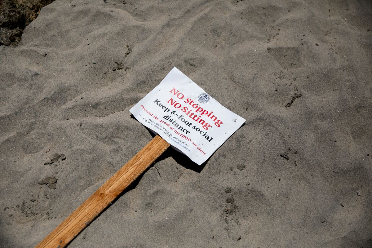 A social distancing advisory lays on the sand at Ocean Beach ahead of Memorial Day Weekend on May 22, 2020 in San Diego, California.
