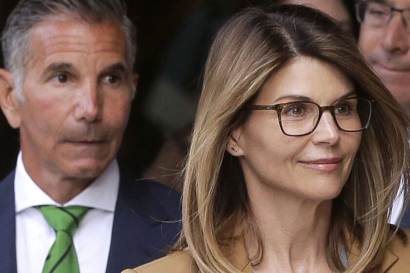FILE - In this April 3, 2019 file photo, actress Lori Loughlin, front, and husband, clothing designer Mossimo Giannulli, left, depart federal court in Boston after facing charges in a nationwide college admissions bribery scandal. Loughlin and her husband Giannulli said in court documents Monday, April 15, 2019, that they are pleading not guilty to charges that they took part in a sweeping college admissions bribery scam. (AP Photo/Steven Senne, File)