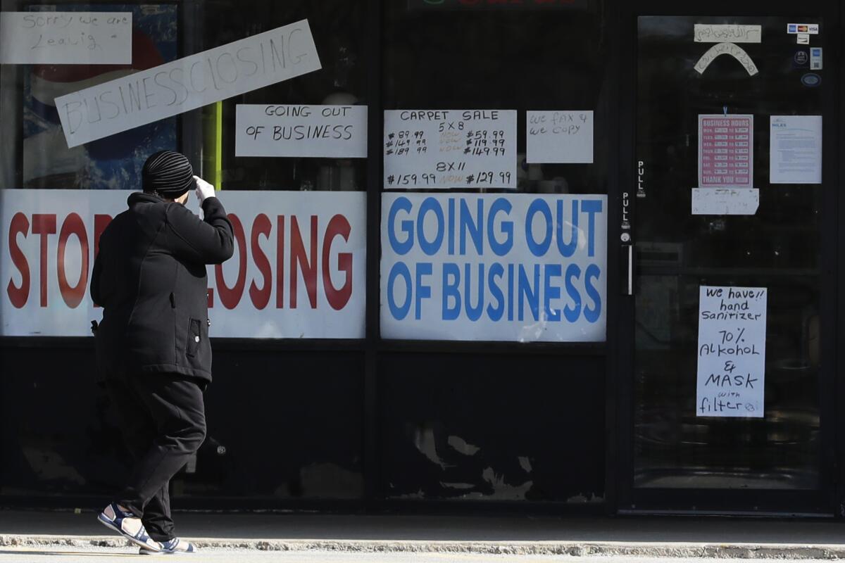 A woman looks at signs at a store on May 13 in Niles, Ill.