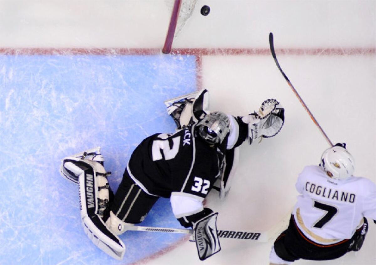 Ducks center Andrew Cogliano, right, shoots wide as Kings goalie Jonathan Quick attempts to block his shot.