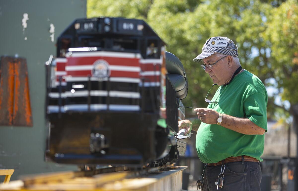 Hank Castignetti, a member of the Orange County Model Engineers, works on the club's new locomotive on Wednesday.