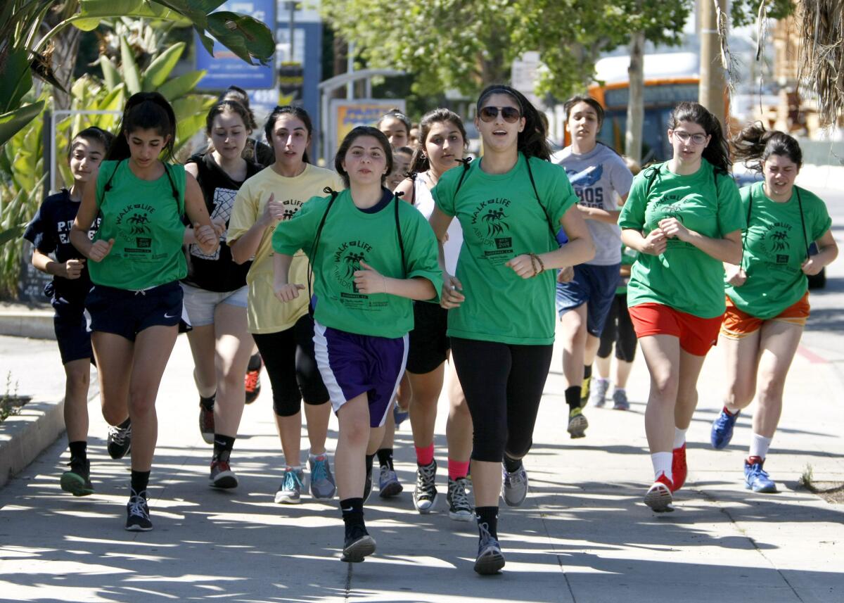 Pilibos Armenian School students dash out in front of others during the Ninth Annual Armenian Bone Marrow Walk at Glendale Memorial Hospital on Saturday, May 3, 2014.