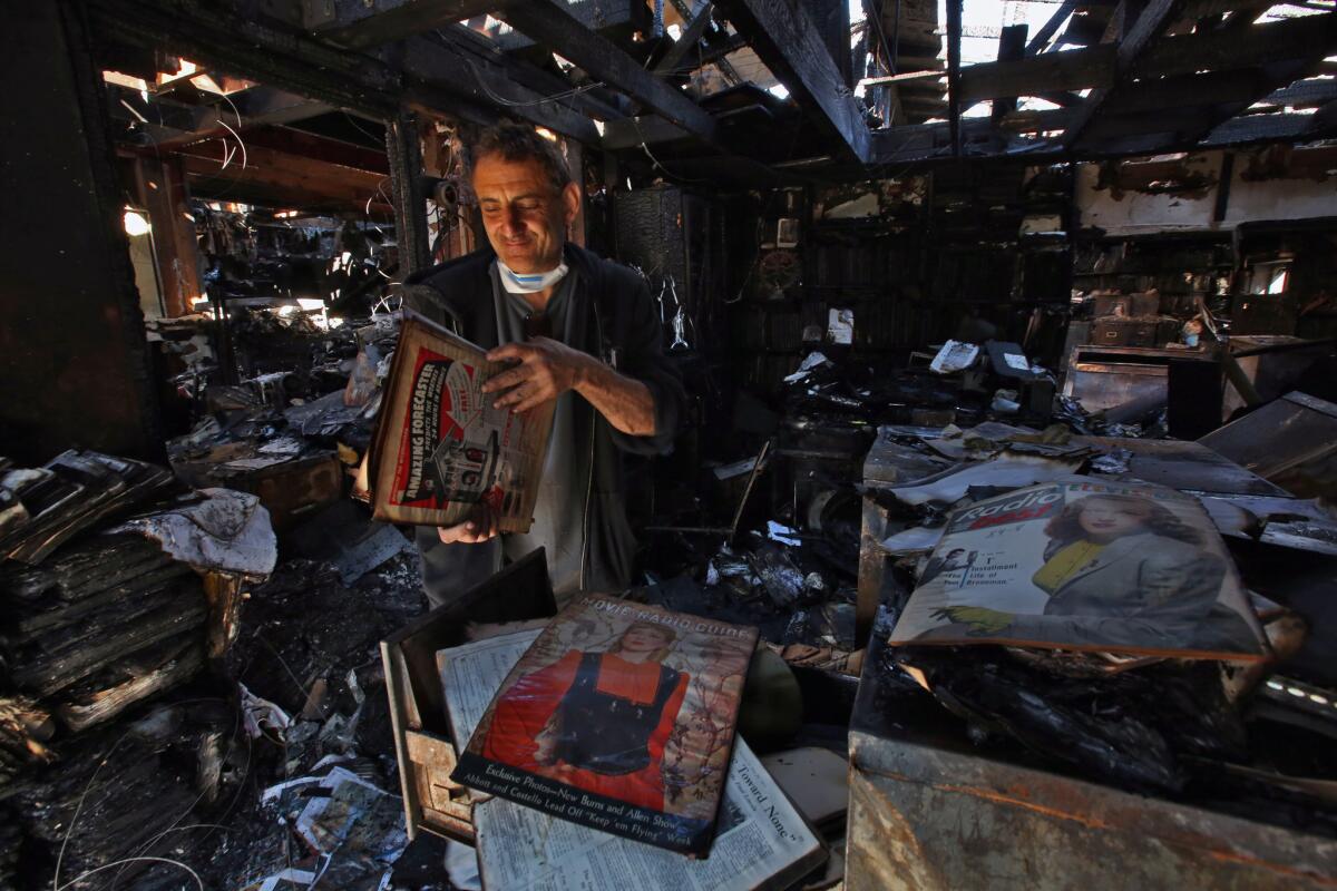 Richard Silva, 56, surveys the charred remains of his Encino home after a fire that caused moderate burn and smoke inhalation injuries to his 86-year-old mother Ruth Silva.