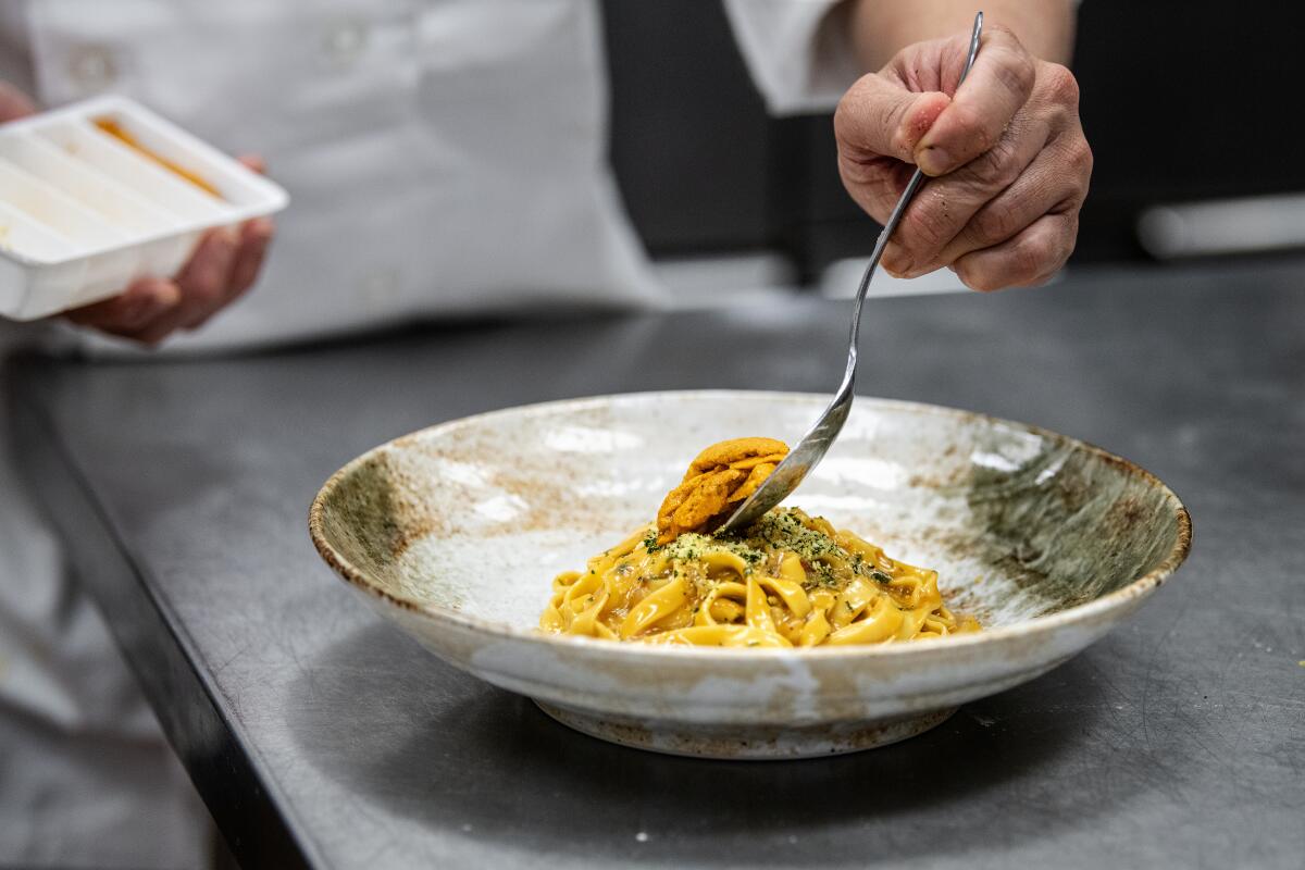 Chef Ramir DeCastro plates the uni pasta at Robata En in Las Vegas.