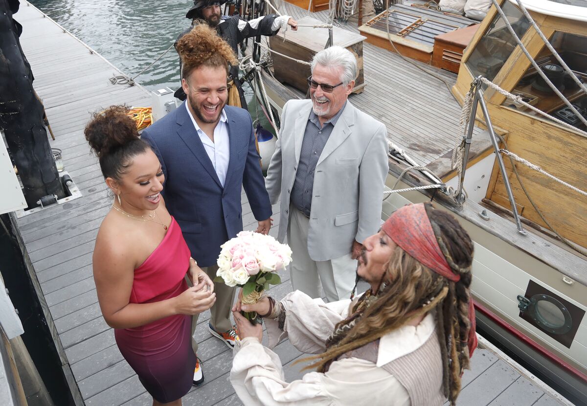 Mr. Irrelevant Grant Stuard and his wife Josie, are greeted by the fictional Capt.  Jack Sparrow.