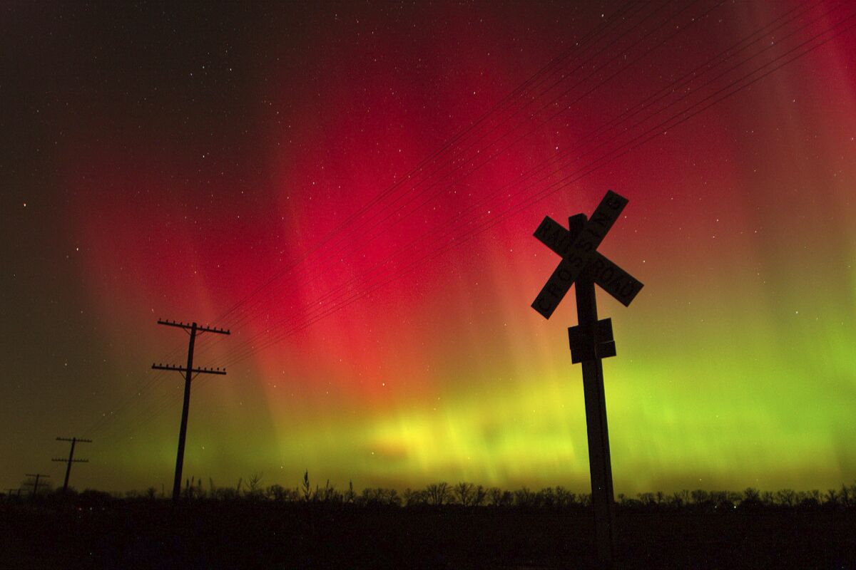 FILE - In this Nov. 8, 2004, file photo, the aurora borealis lights up the sky northwest of Lawrence, Kan. The phenomenon, also called northern lights, occurs when electrically charged particles from the sun enter the earth's atmosphere. Robert Rutledge, of the U.S. government's space weather prediction center said Thursday, Dec. 10, 2020, that stargazers in the continental 48 states have very little chance of seeing the northern lights this week despite an initial promising forecast. (Scott McClurg/The Lawrence Journal-World via AP, File)