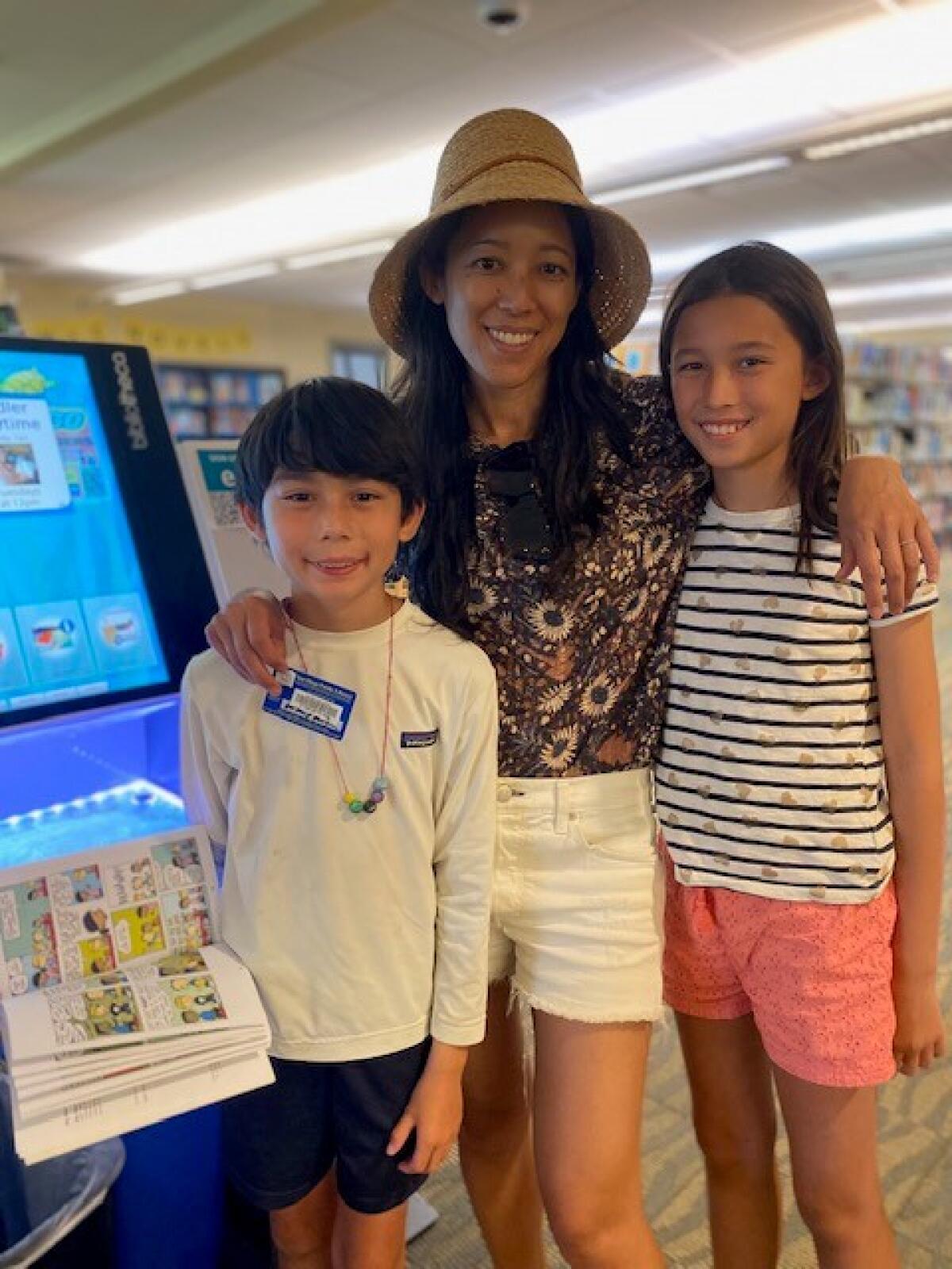 Emily McKinnon and her children Jack, 8, and Nina, 11, visit the La Jolla/Riford Library.
