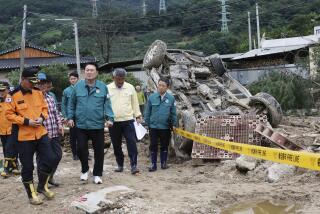 South Korean President Yoon Suk Yeol, fourth from left, looks around a flood damaged area in Yecheon, South Korea, Monday, July 17, 2023. (Jin Sung-chul/Yonhap via AP)