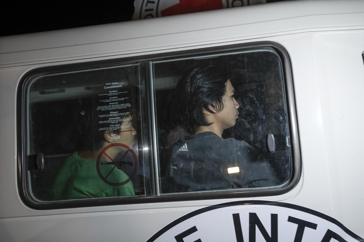 A Red Cross vehicle carrying Thai hostages drives by at the Gaza Strip crossing into Egypt in Rafah 